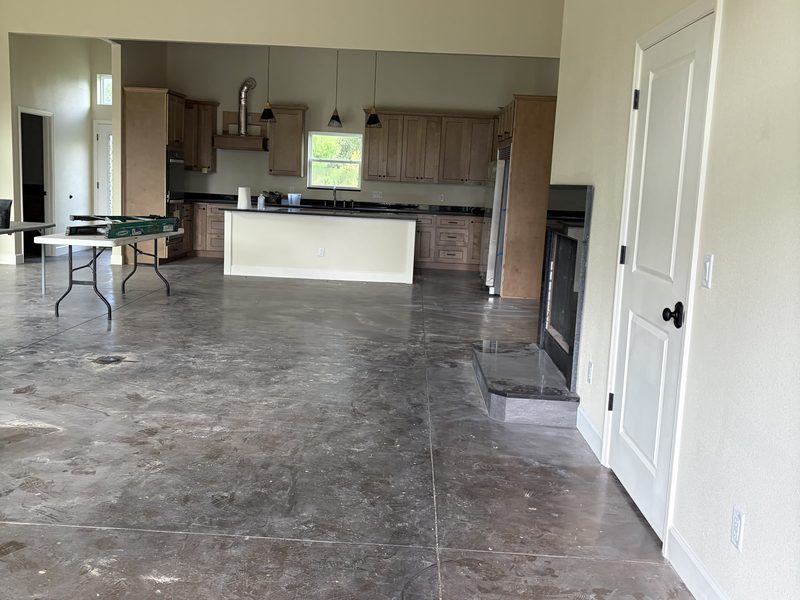 Dust-covered concrete floor and work table on a job site before the final clean
