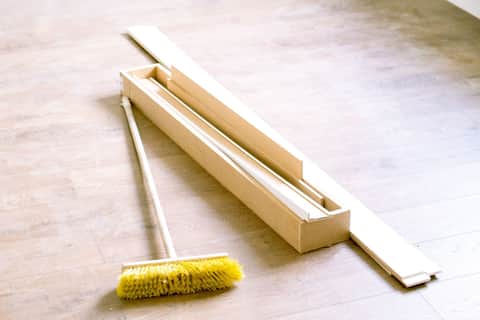 Push broom sweeping a newly installed floor