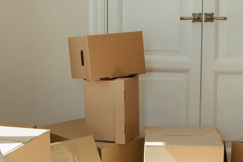 Moving boxes stacked in a clean, empty room