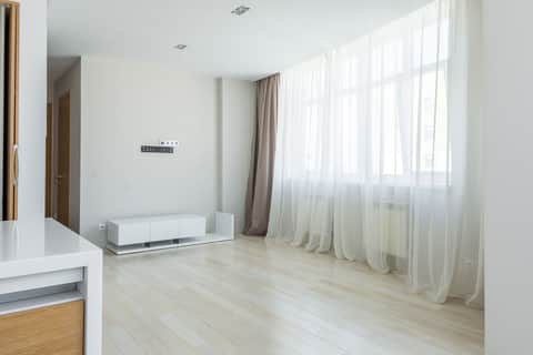 Airy room with sheer curtains after a seasonal refresh